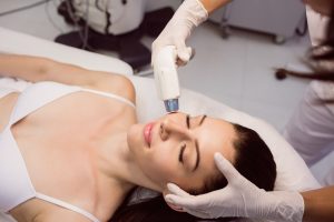 dermatologist-giving-facial-massage-through-soniclifting_107420-65215