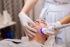 young-beautiful-girl-lies-beautician-s-table-receives-procedures-with-professional-apparatus-skin-rejuvenation-moisturizing_343596-4221